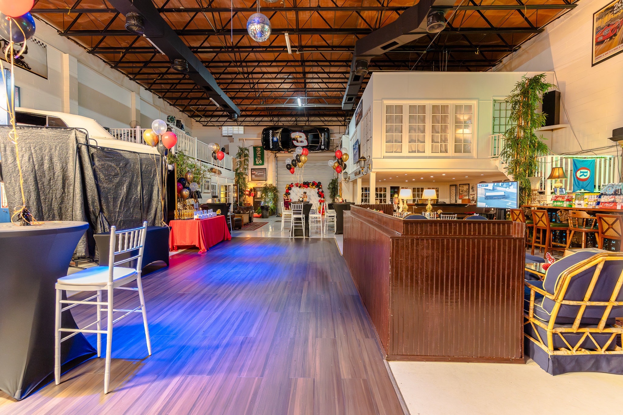 The dance floor at 51 Club lit blue, with cars and lounge seating alongside
