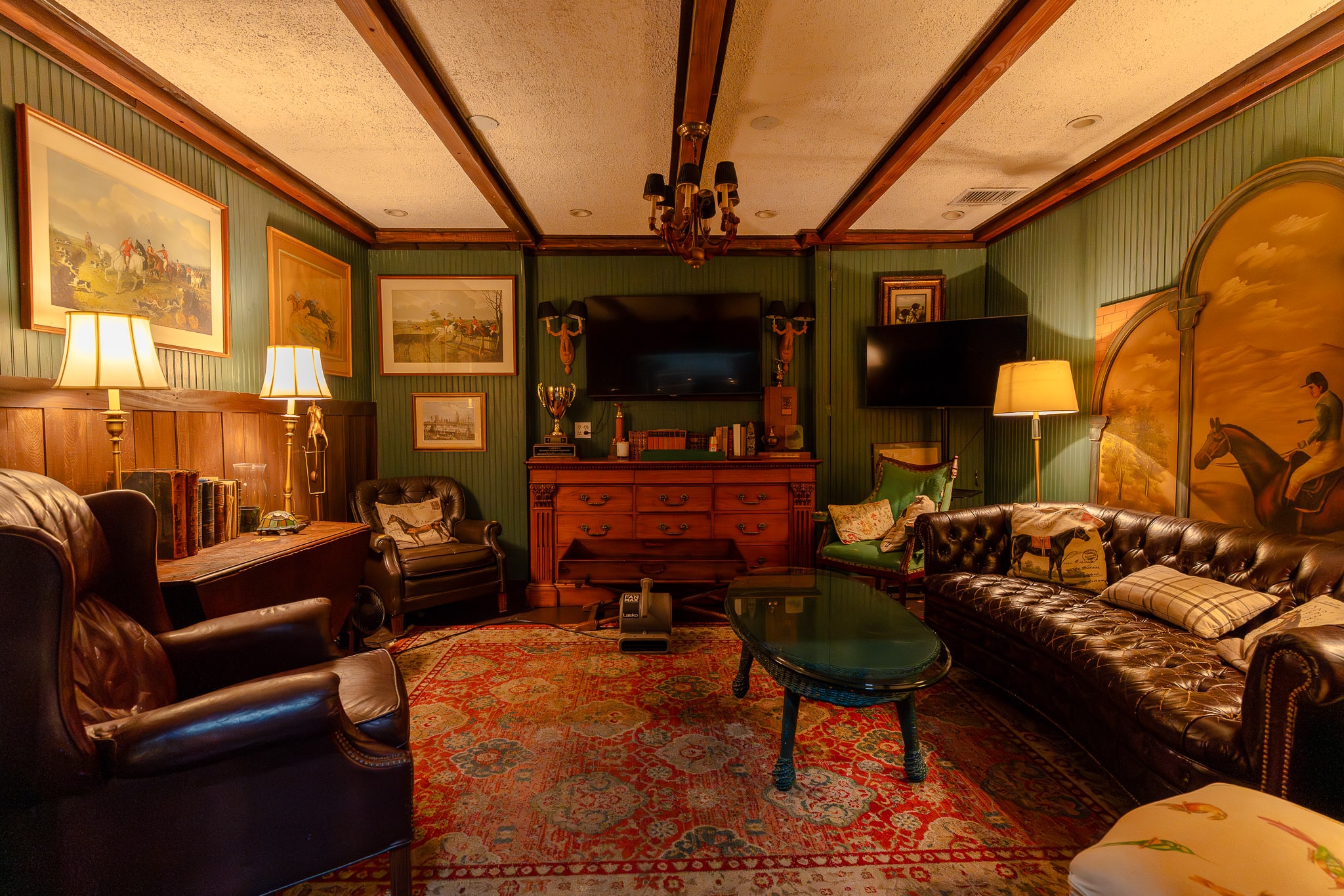 The Polo Room VIP lounge at 51 Club with Chesterfield leather seating, equestrian art and wood paneling