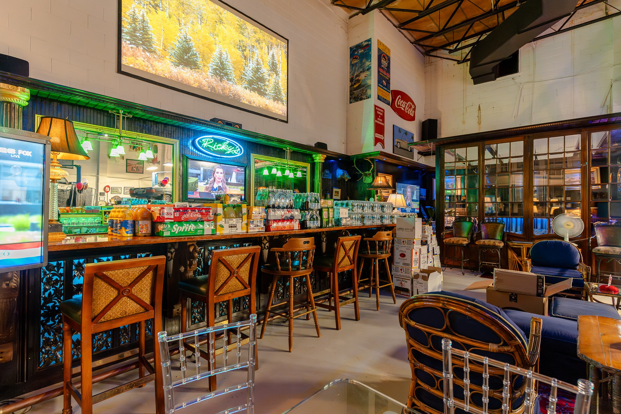 The 40-foot teak bar at 51 Club, backed by neon signs and shelves of memorabilia